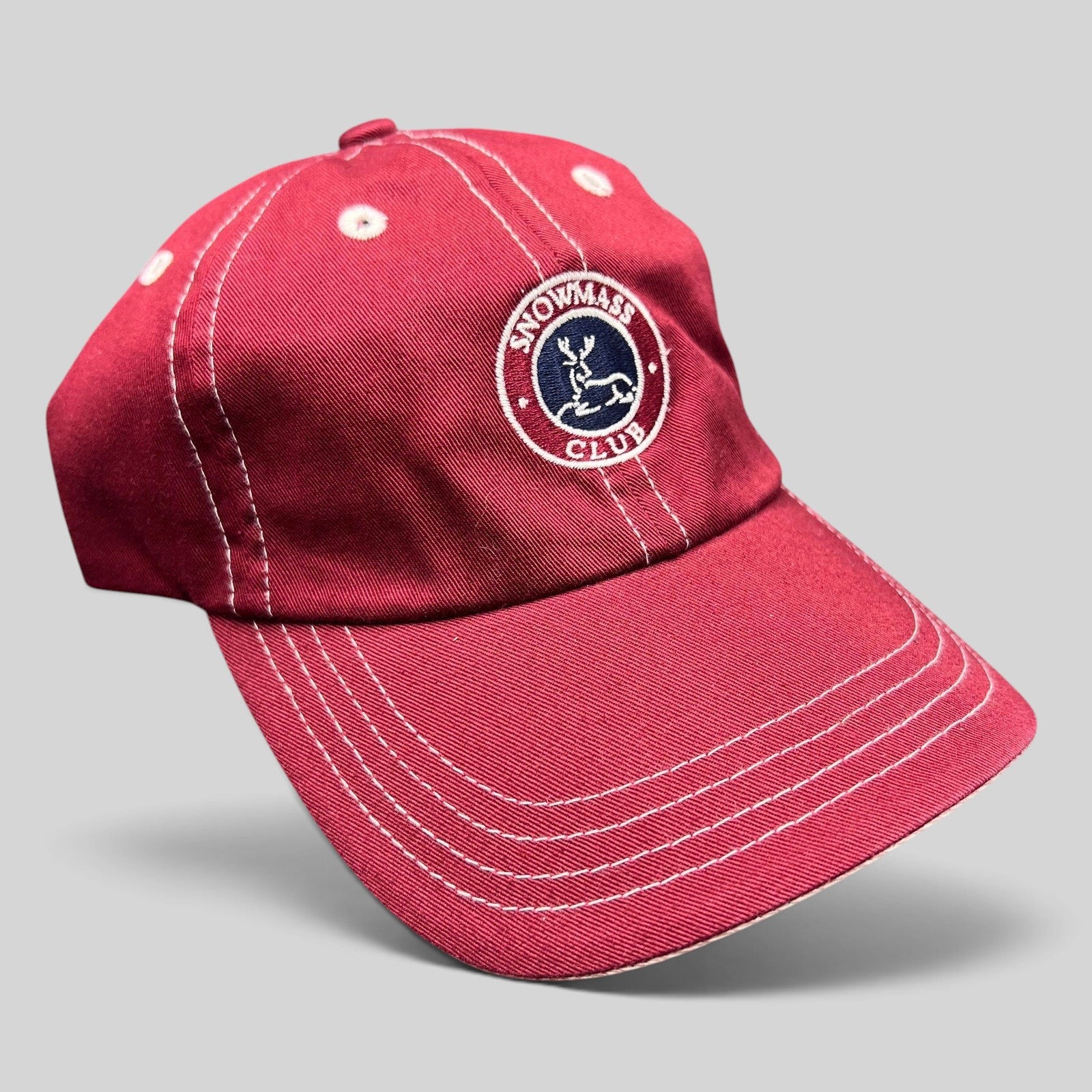 Raree Finds red Imperial strapback hat with white contrast stitching and Snowmass Club deer crest embroidery