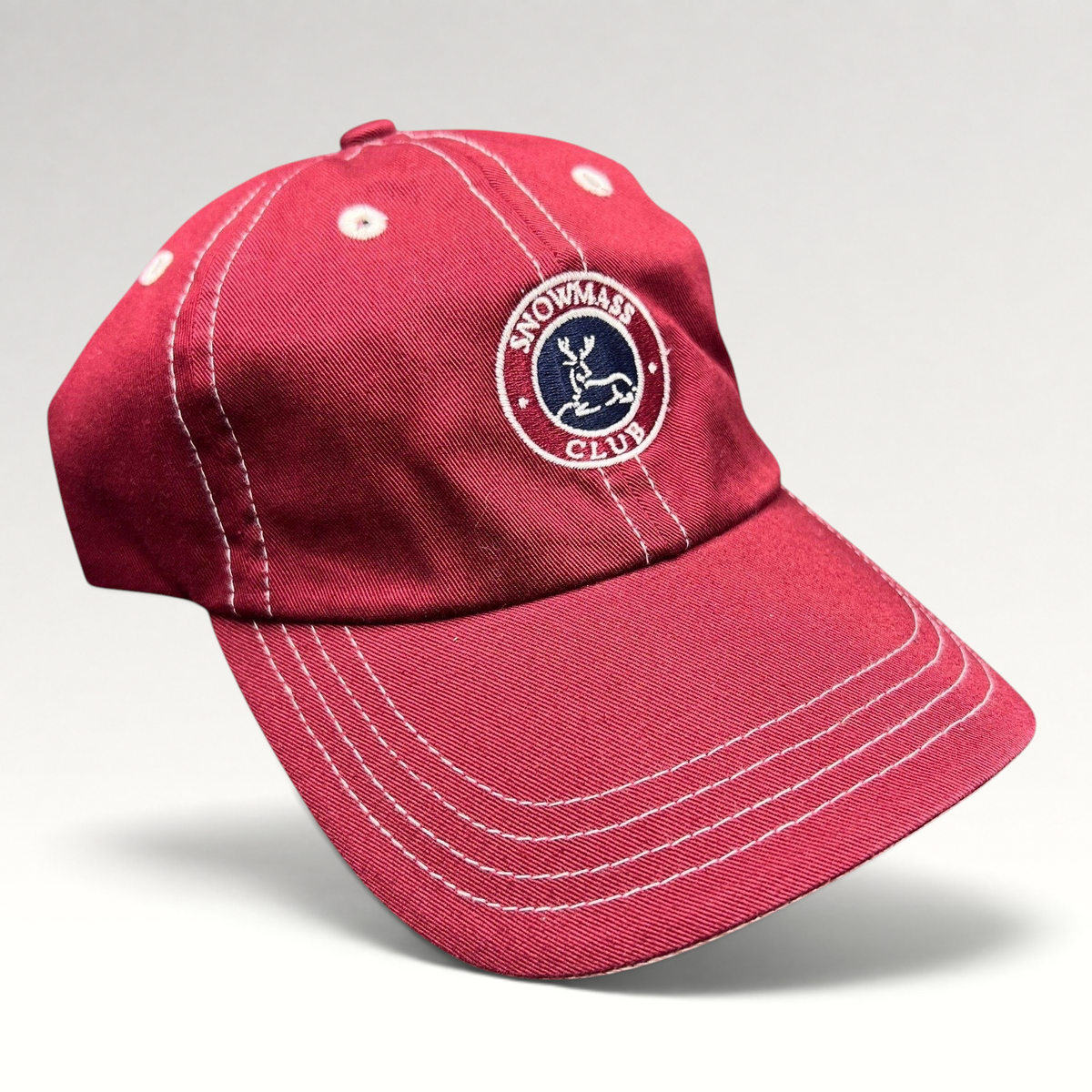 Raree Finds red Imperial strapback hat with white contrast stitching and Snowmass Club deer crest embroidery