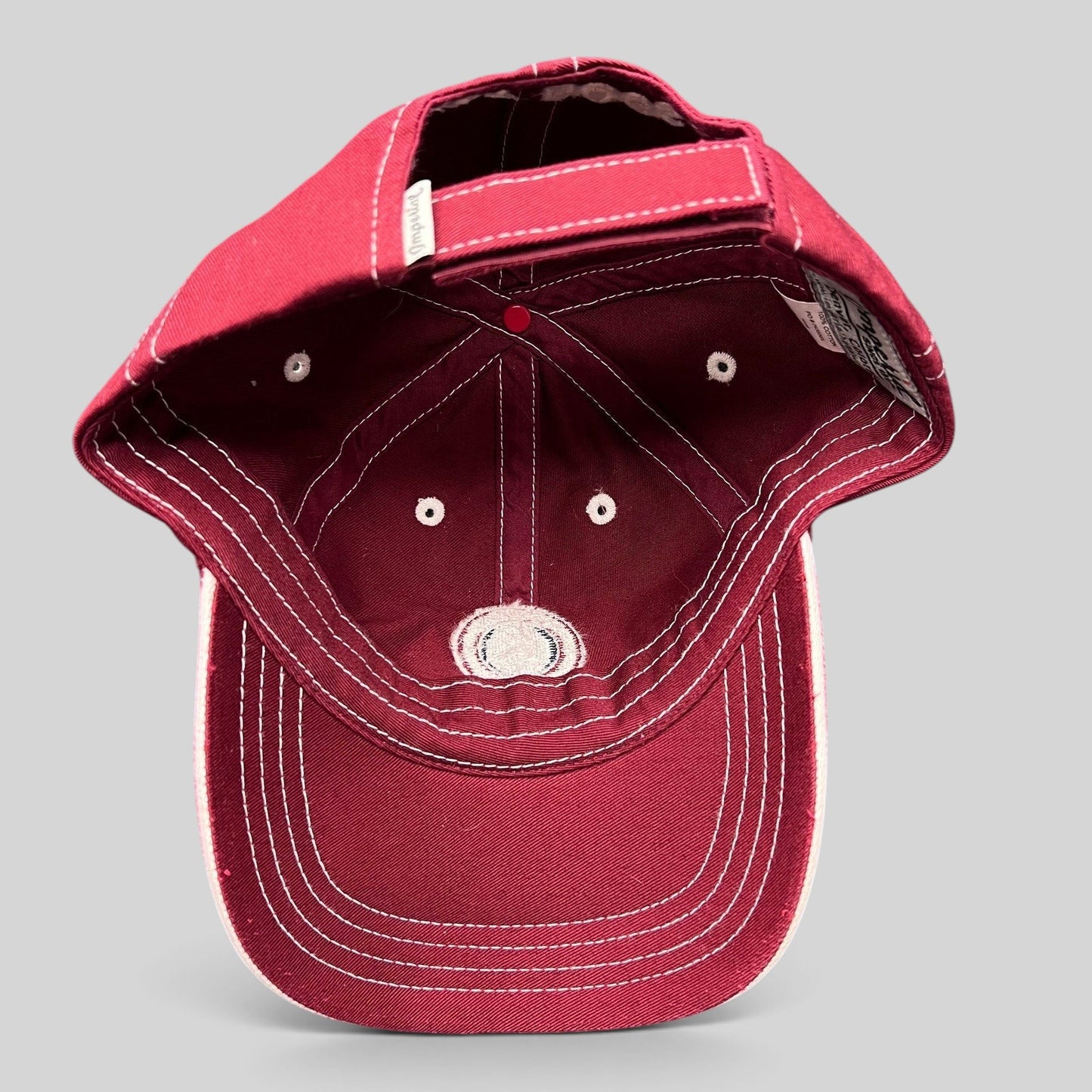 Raree Finds red Snowmass Club strapback hat with white contrast stitching and adjustable back strap