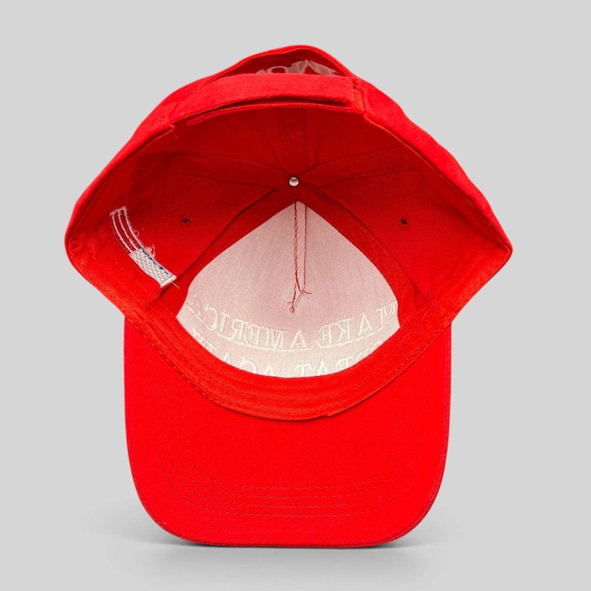 Raree Finds red strapback hat with white Make America Great Again embroidery, viewed from the inside showing lining.