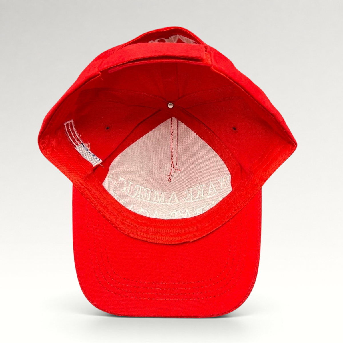 Raree Finds red strapback hat with white Make America Great Again embroidery, viewed from the inside showing lining.