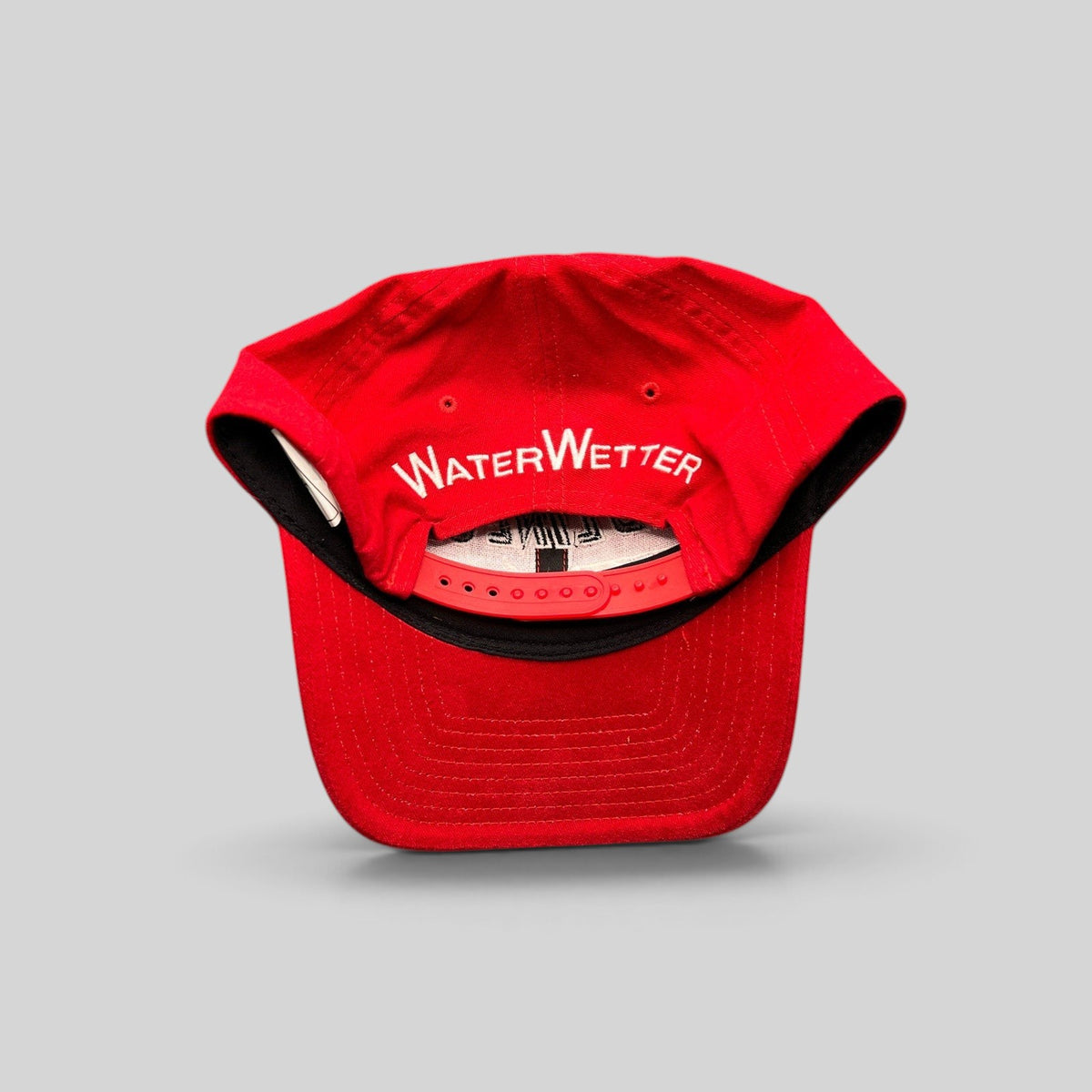 Raree Finds vintage red snapback hat with white WaterWetter embroidery on the back and adjustable plastic closure.