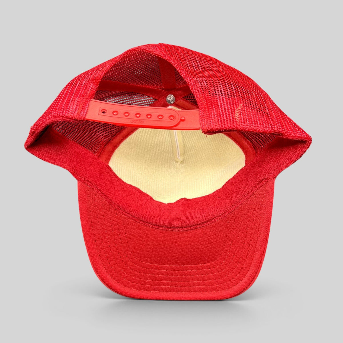 Raree Finds red and white mesh trucker hat with adjustable snapback closure and curved brim, rear view