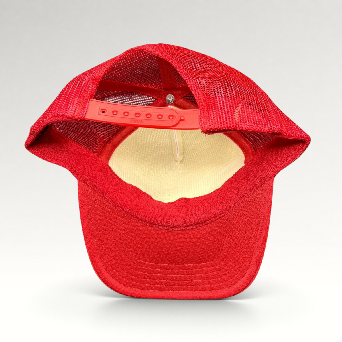 Raree Finds red and white mesh trucker hat with adjustable snapback closure and curved brim, rear view
