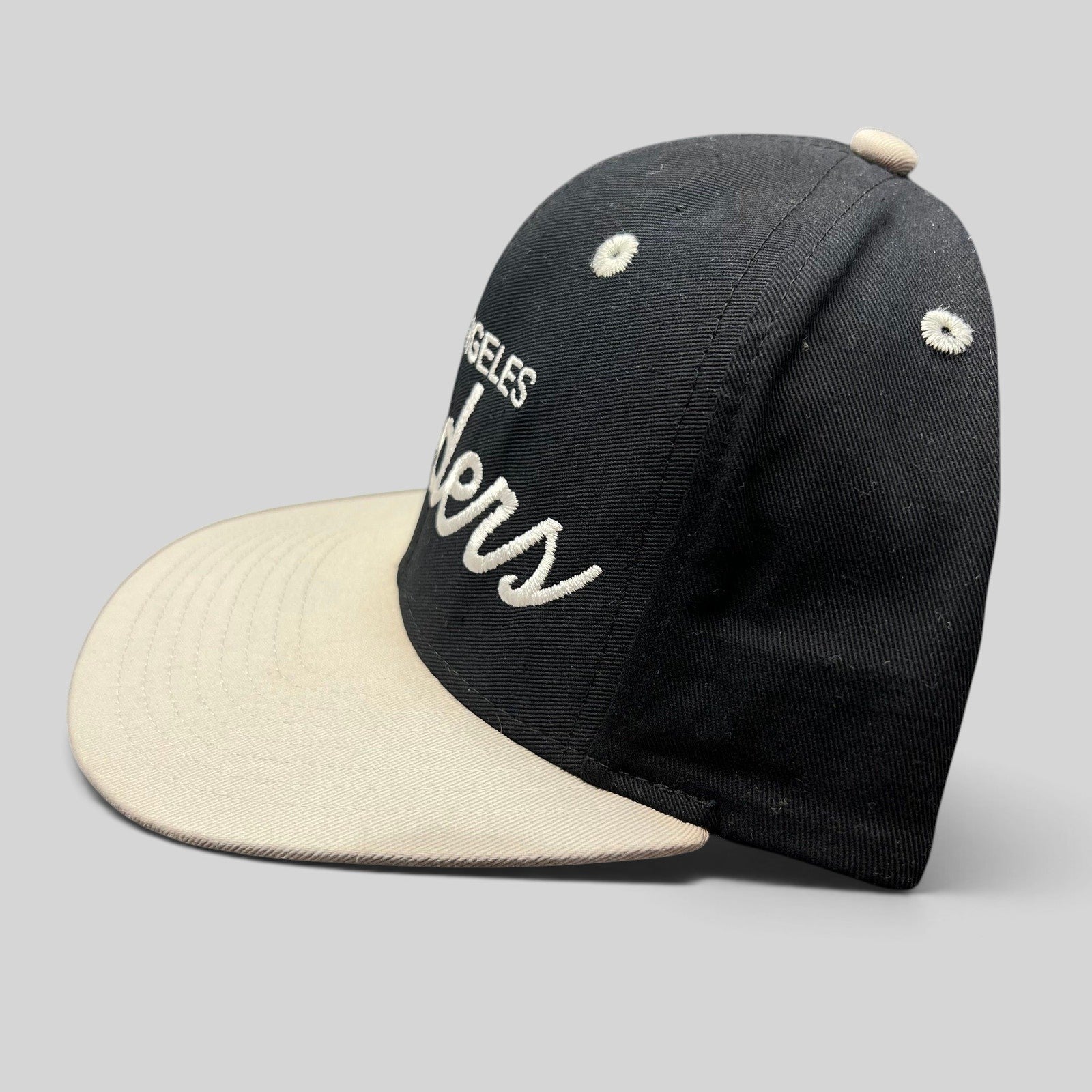 Raree Finds Reebok NFL Vintage Collection LA Raiders snapback hat with black crown, grey brim, and white embroidery.