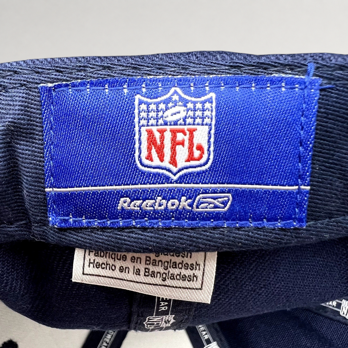 Raree Finds Reebok NFL Denver Broncos hat interior label with blue branding and Bangladesh origin tag