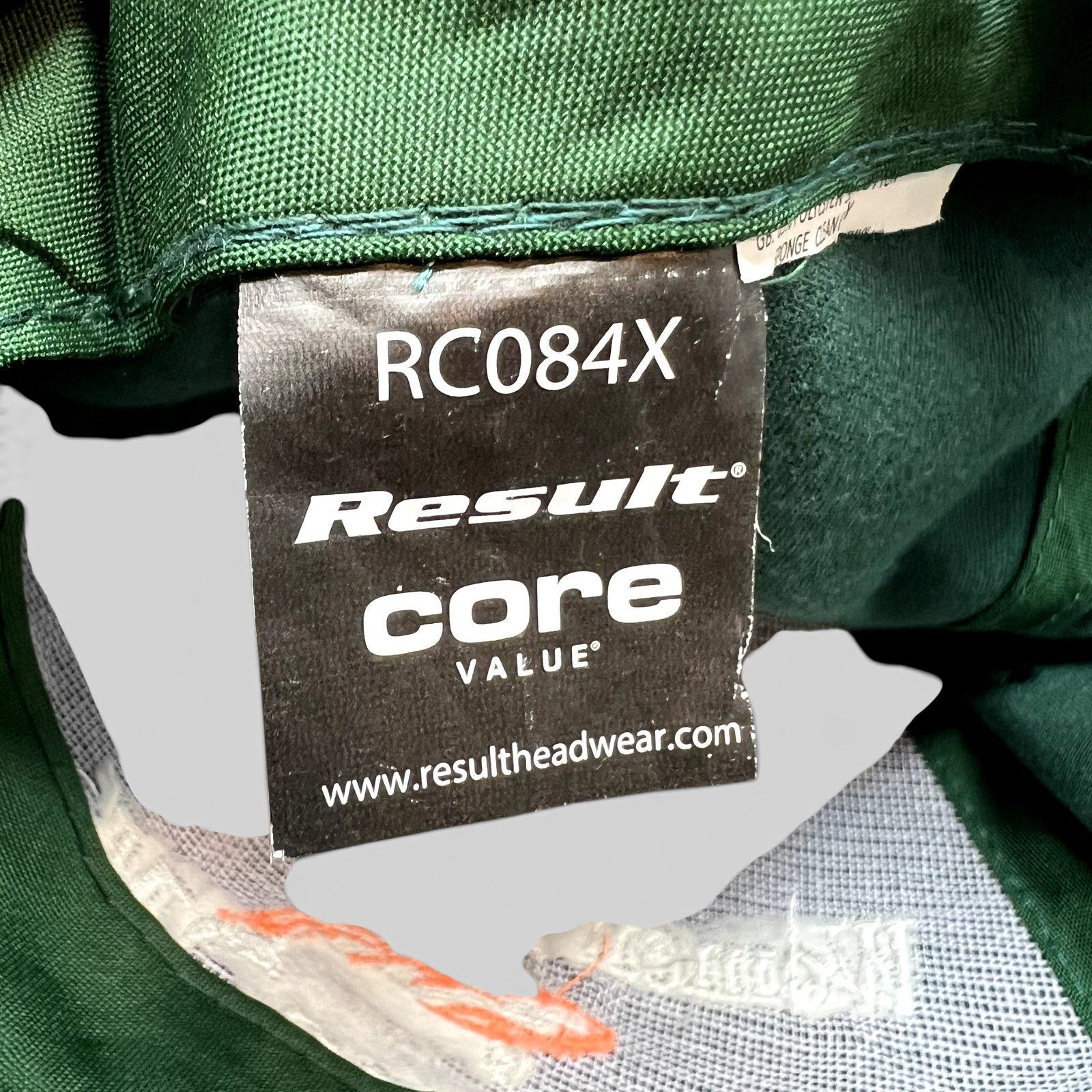 Raree Finds forest green fishing hat interior label showing Result Core Value RC084X branding