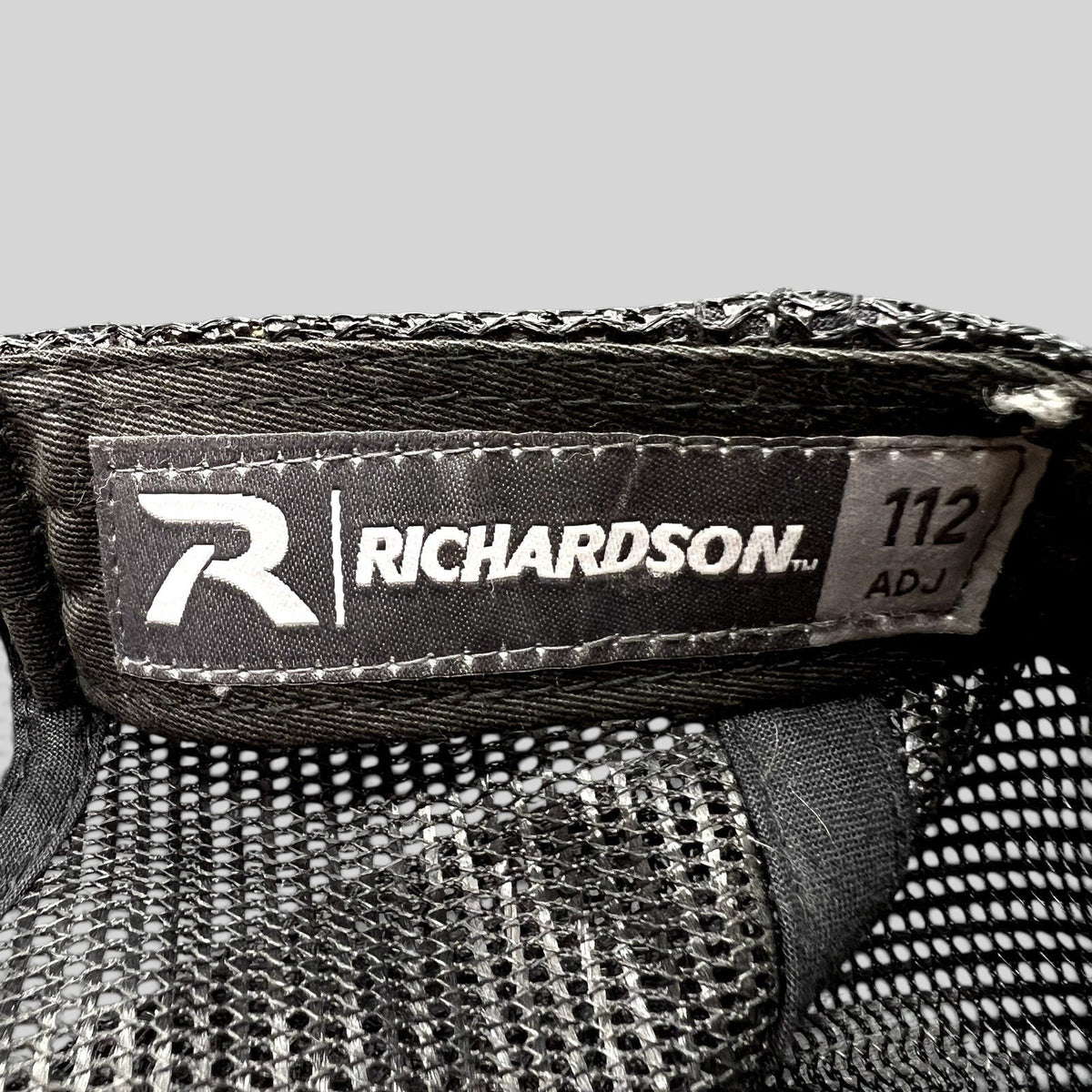 Raree Finds Richardson 112 trucker hat interior label with black mesh backing and adjustable snapback construction.