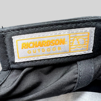 Raree Finds Richardson Outdoor label inside a black performance snapback hat with orange and grey branding