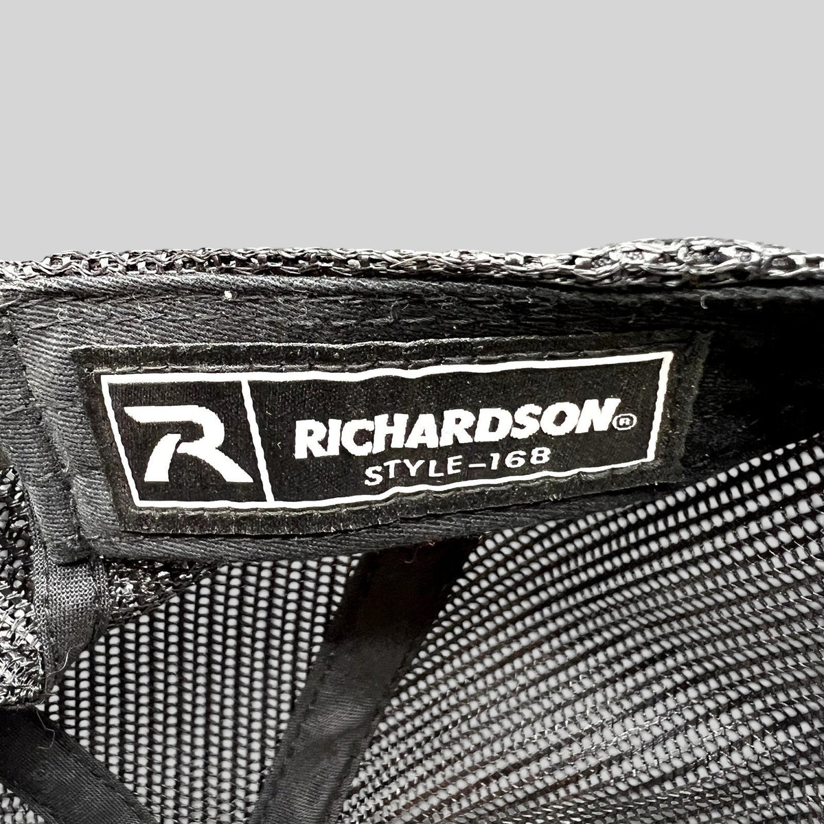 Raree Finds Richardson style 168 interior label on a black mesh trucker hat