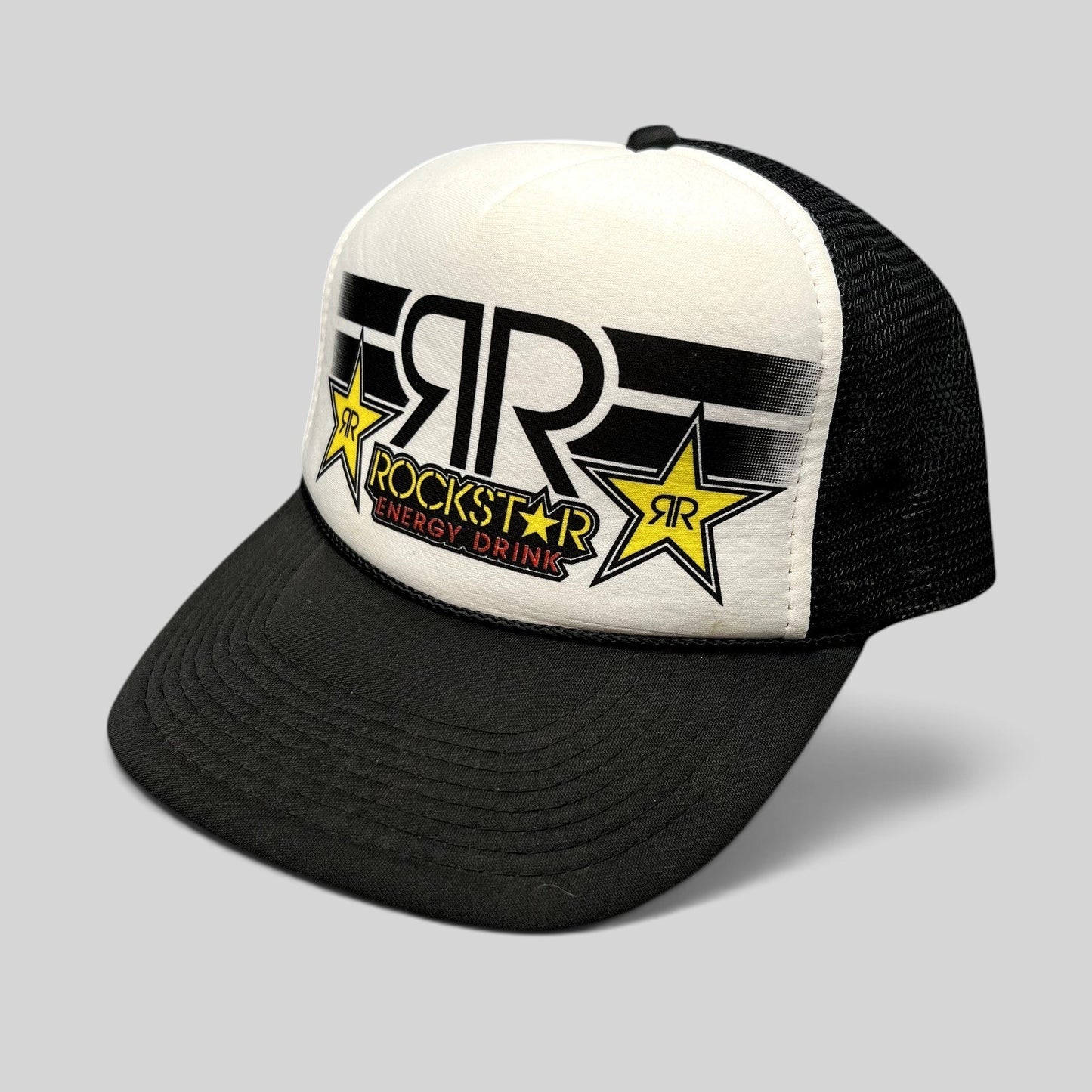 Raree Finds vintage Y2K Rockstar Energy Drink trucker hat with black brim, white foam front, and black mesh back.