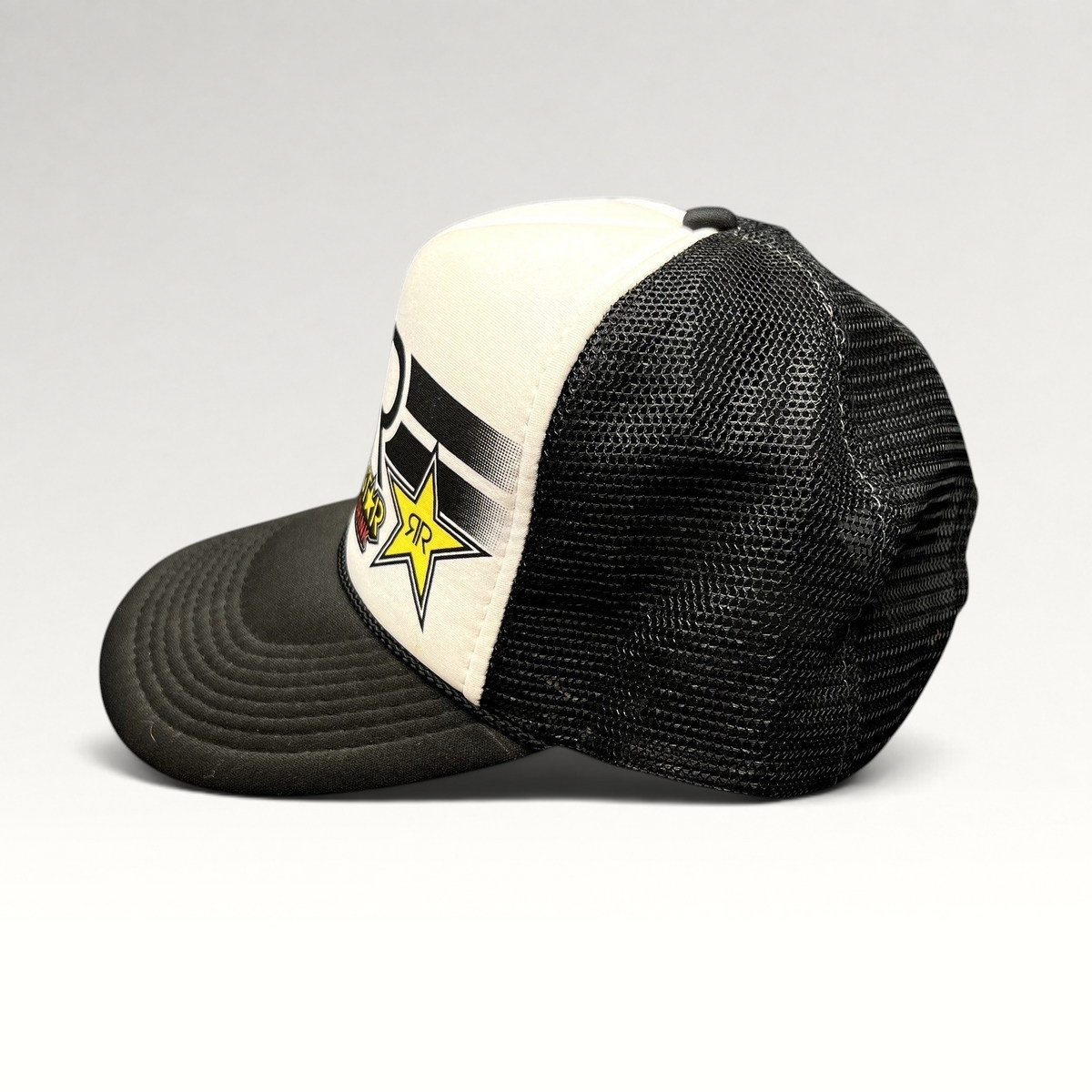 Raree Finds vintage Y2K Rockstar Energy Drink trucker hat with black mesh back, white foam front, and snapback closure.