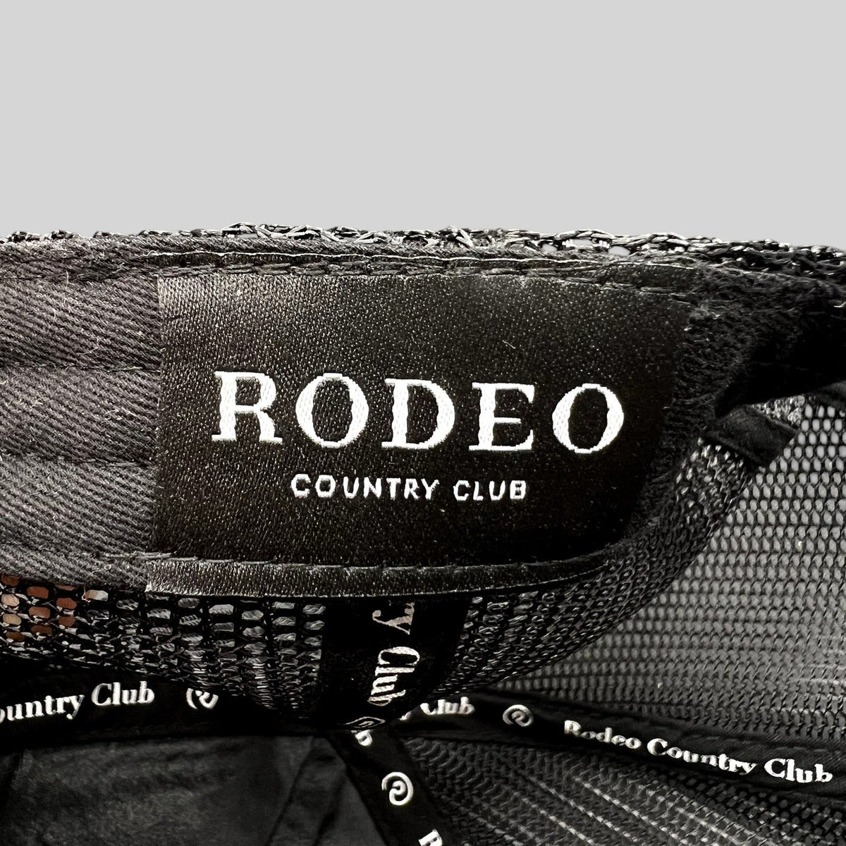 Raree Finds black Rodeo Country Club trucker hat interior label and branded taping detail