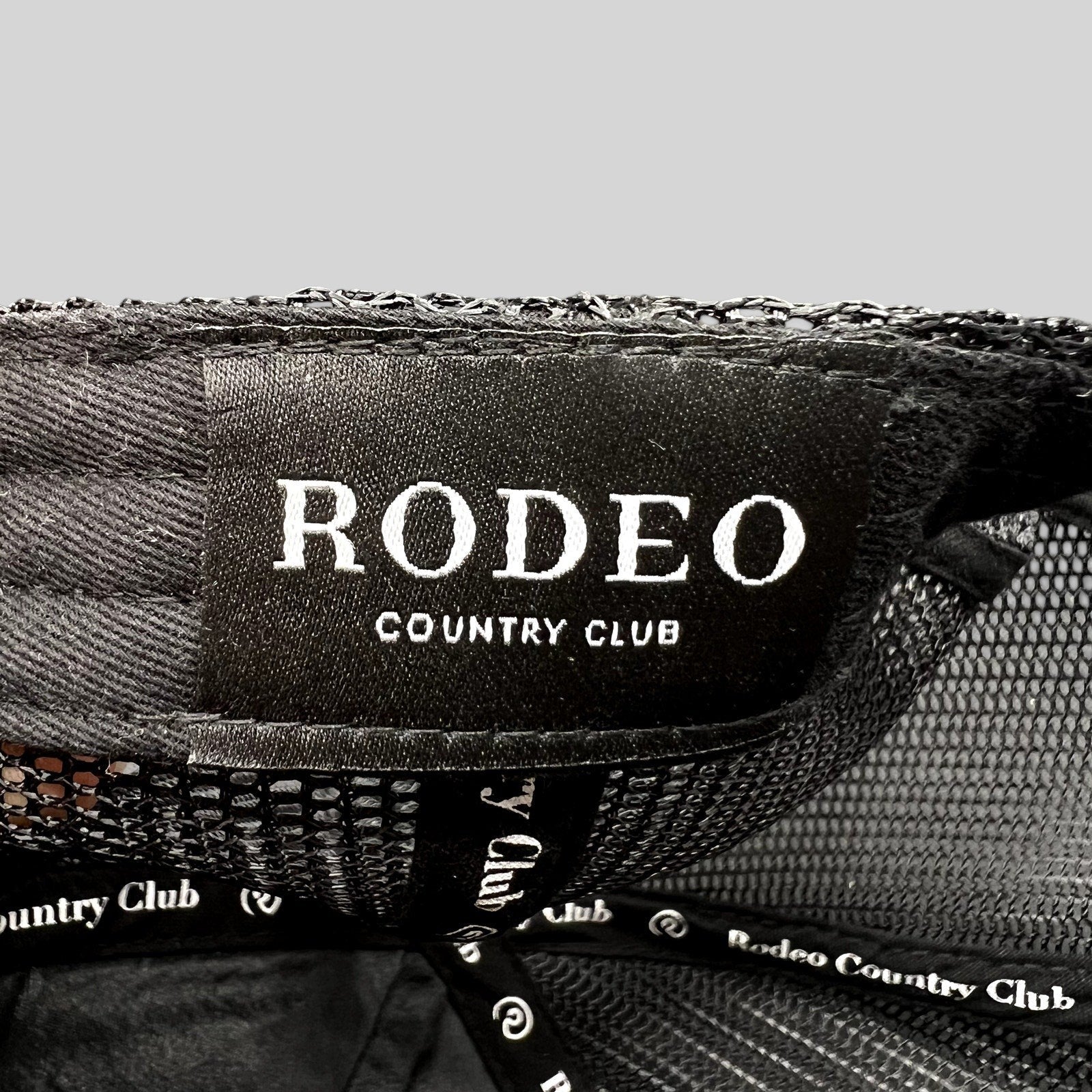 Raree Finds black Rodeo Country Club trucker hat interior label and branded taping detail