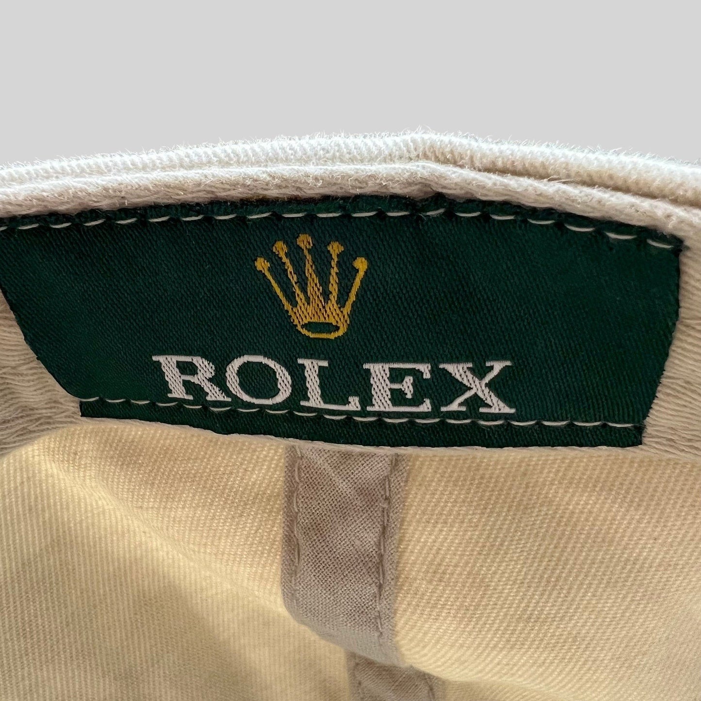 Raree Finds vintage Rolex promotional hat interior label with iconic gold crown logo on green fabric