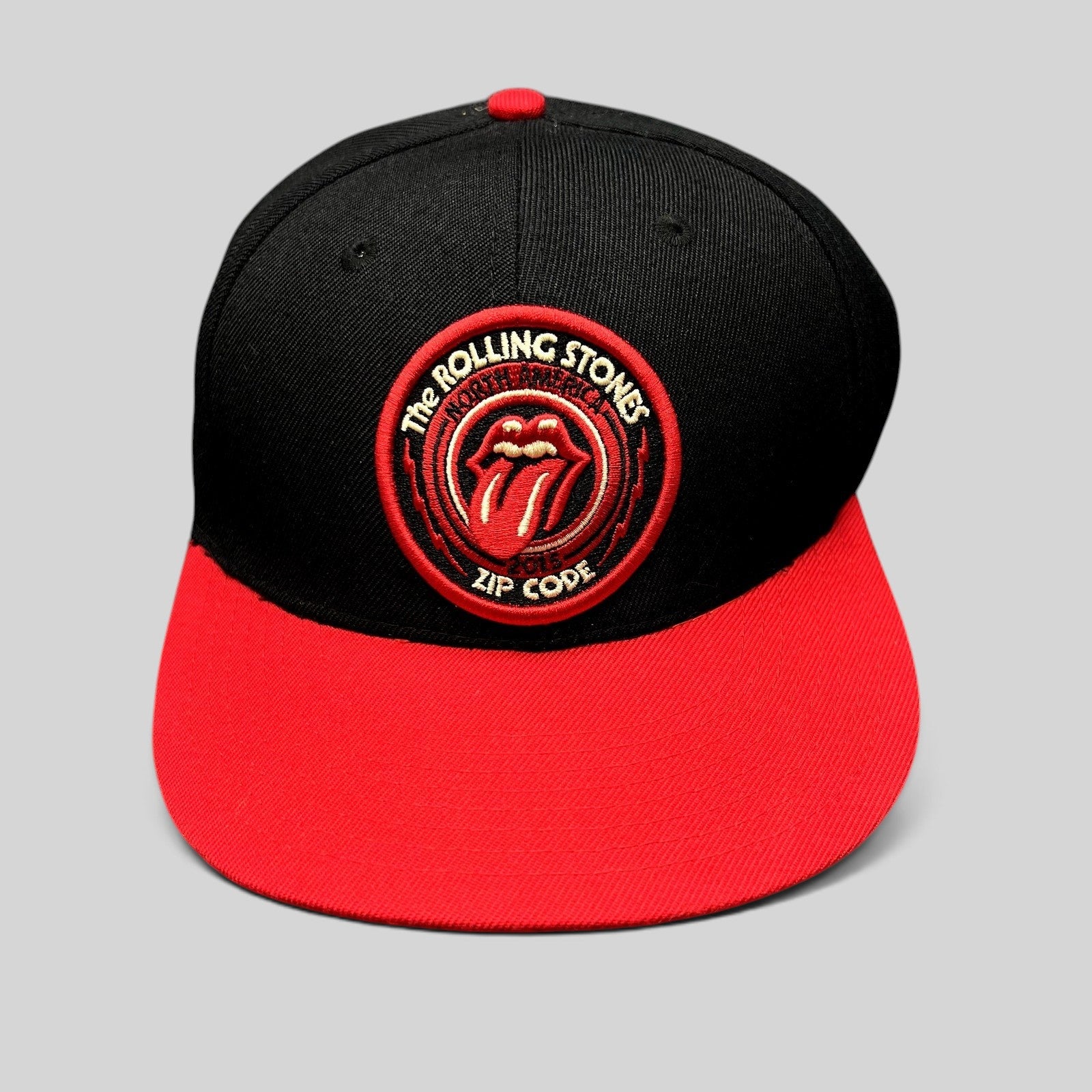 Raree Finds The Rolling Stones Zip Code 2015 tour snapback hat with black crown, red brim, and embroidered logo patch.