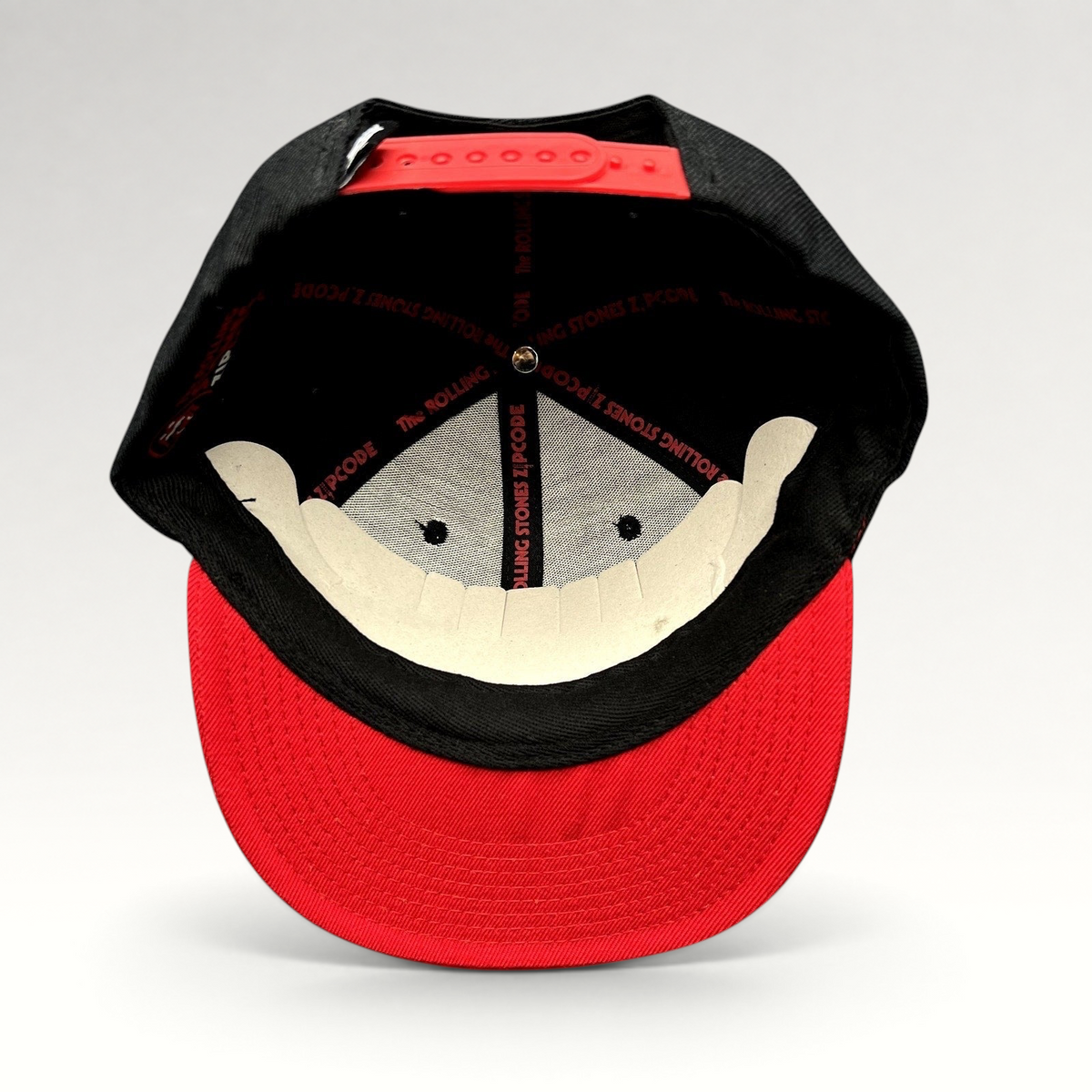 Raree Finds The Rolling Stones Zip Code 2015 tour snapback hat with black crown, red brim, and branded interior tape.