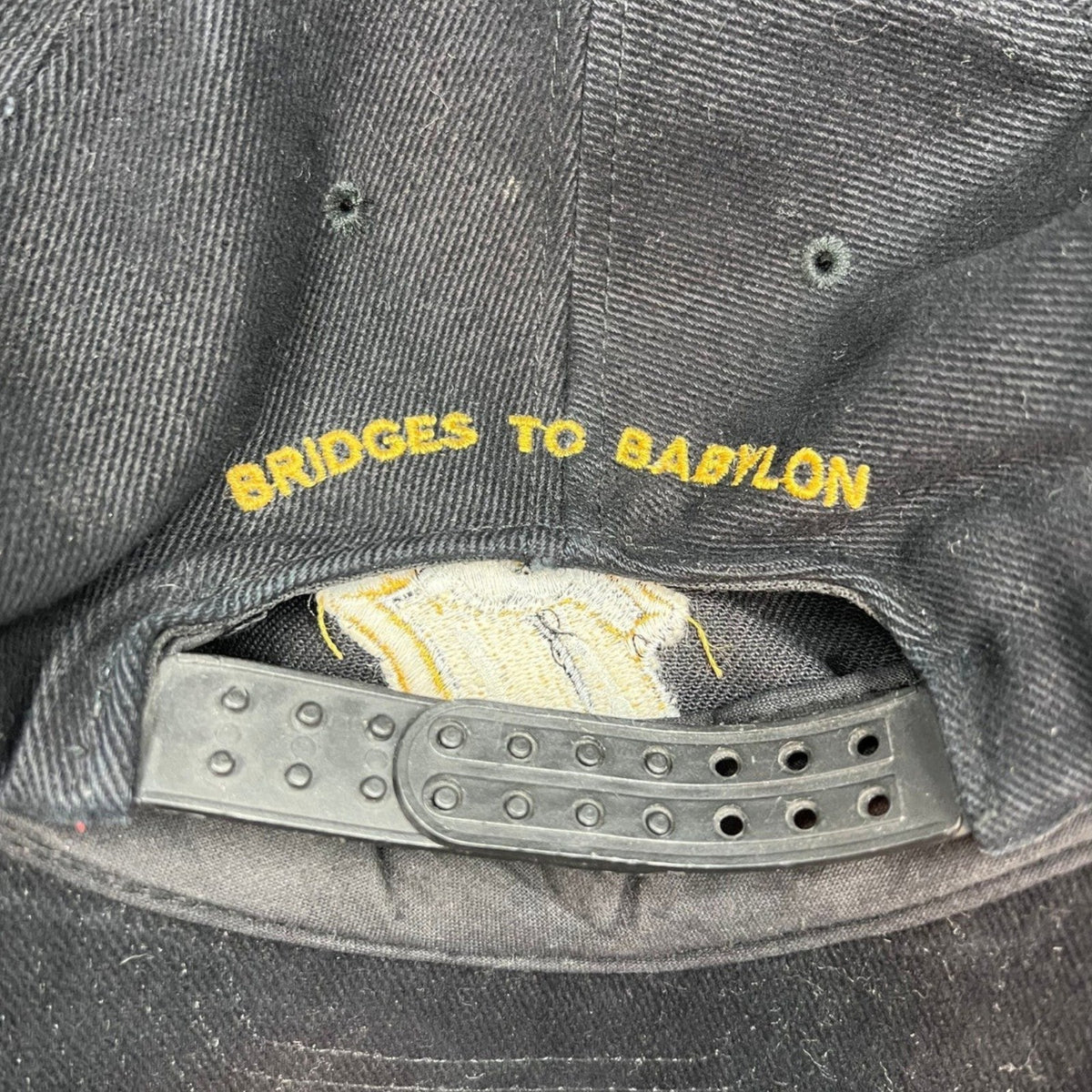 Raree Finds vintage 1997 Rolling Stones Bridges to Babylon black cotton snapback hat with gold embroidered back text