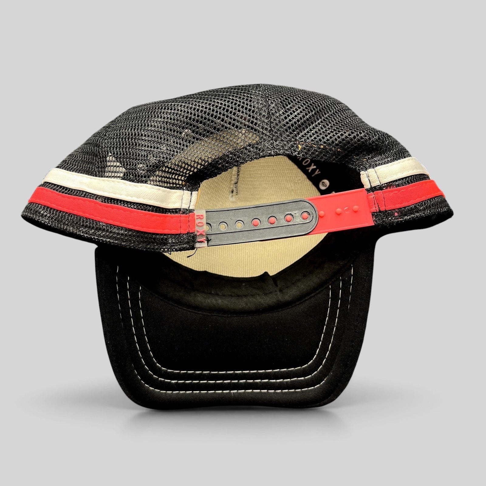 Raree Finds Roxy black trucker hat with pink and white striped mesh back and adjustable red snapback closure