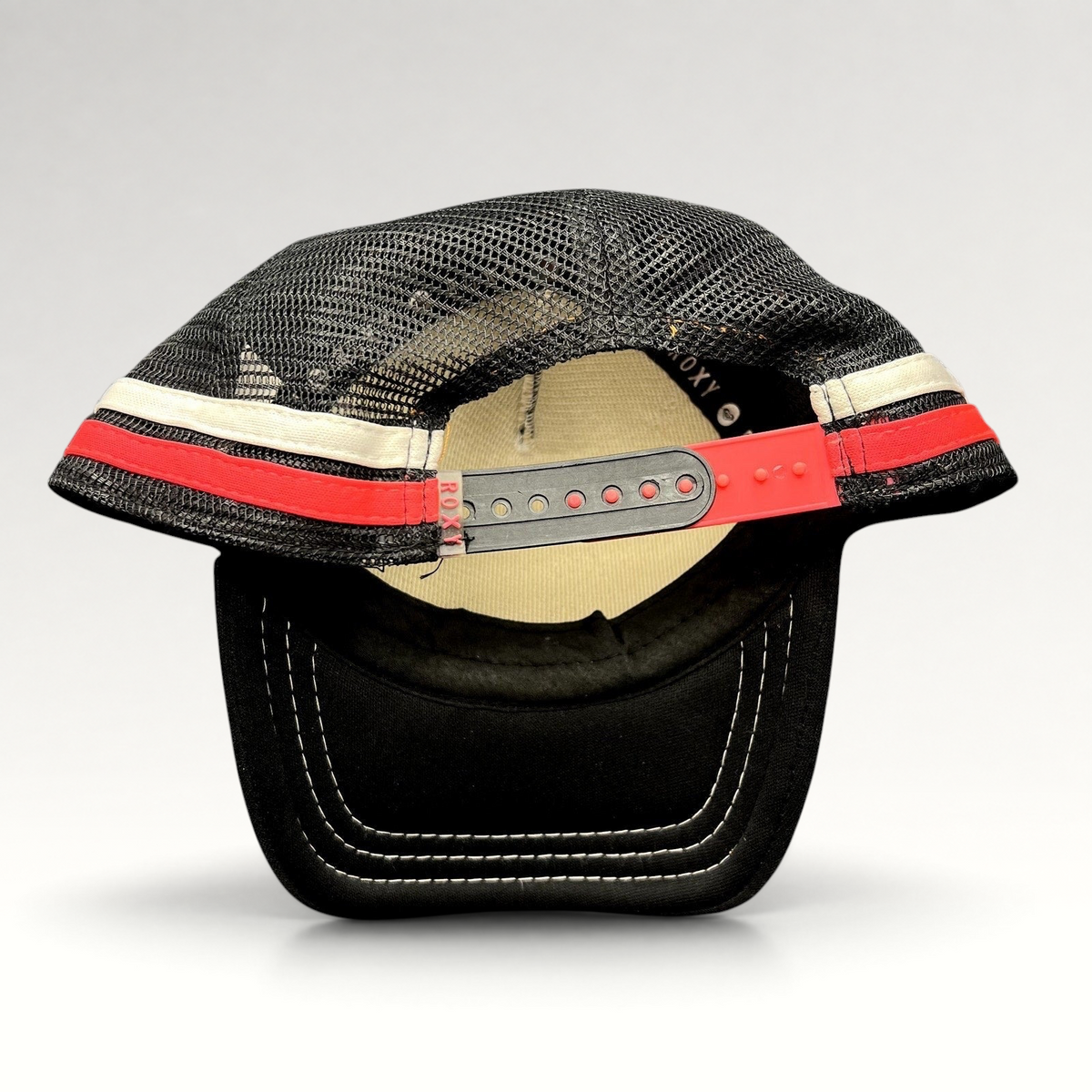 Raree Finds Roxy black trucker hat with pink and white striped mesh back and adjustable red snapback closure