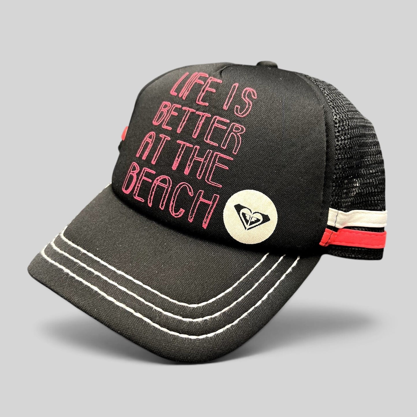Raree Finds Roxy black trucker hat with pink Life Is Better At The Beach embroidery and mesh back