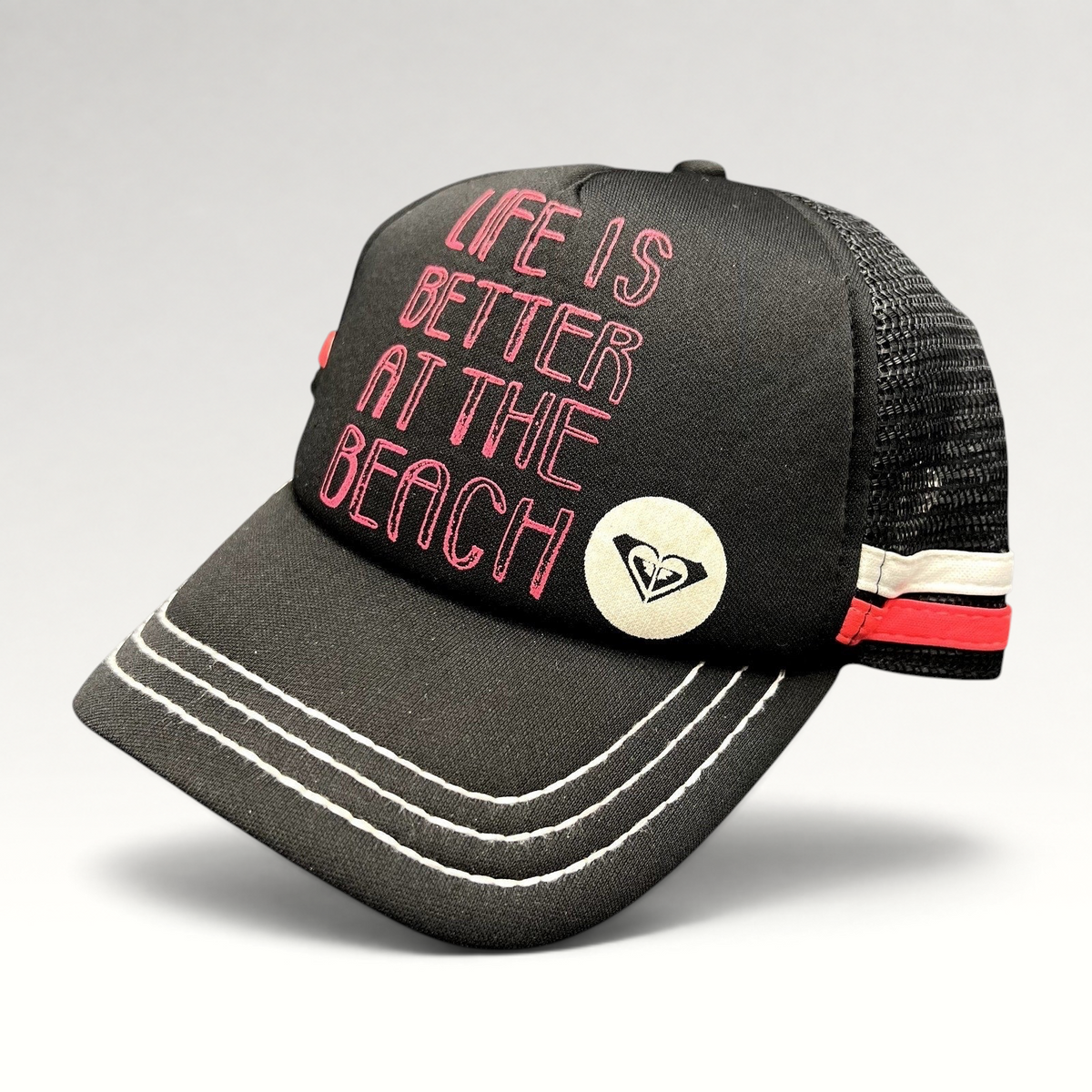 Raree Finds Roxy black trucker hat with pink Life Is Better At The Beach embroidery and mesh back