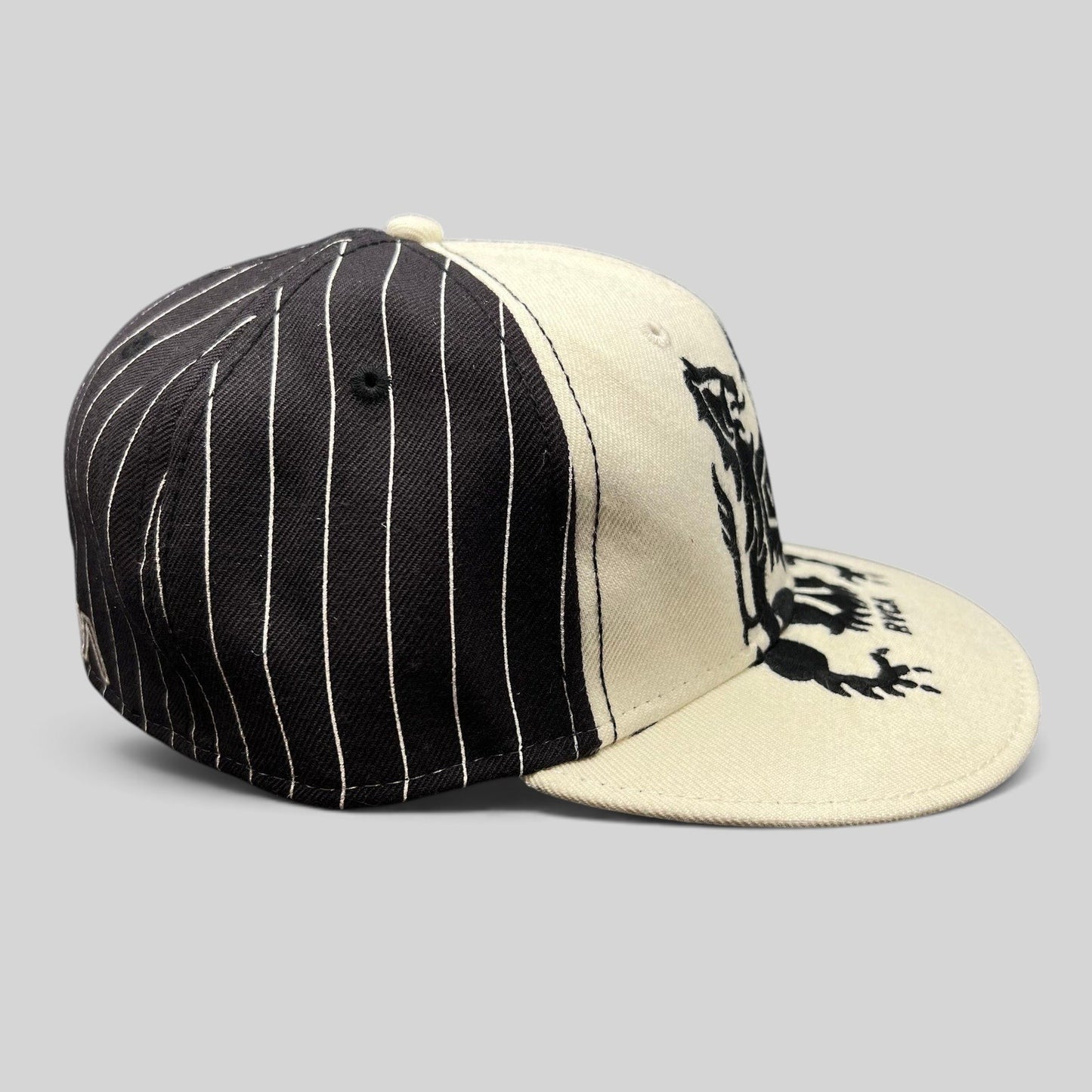 Raree Finds RVCA Y2K black and white pinstripe snapback hat with a bold crest graphic on the front panel