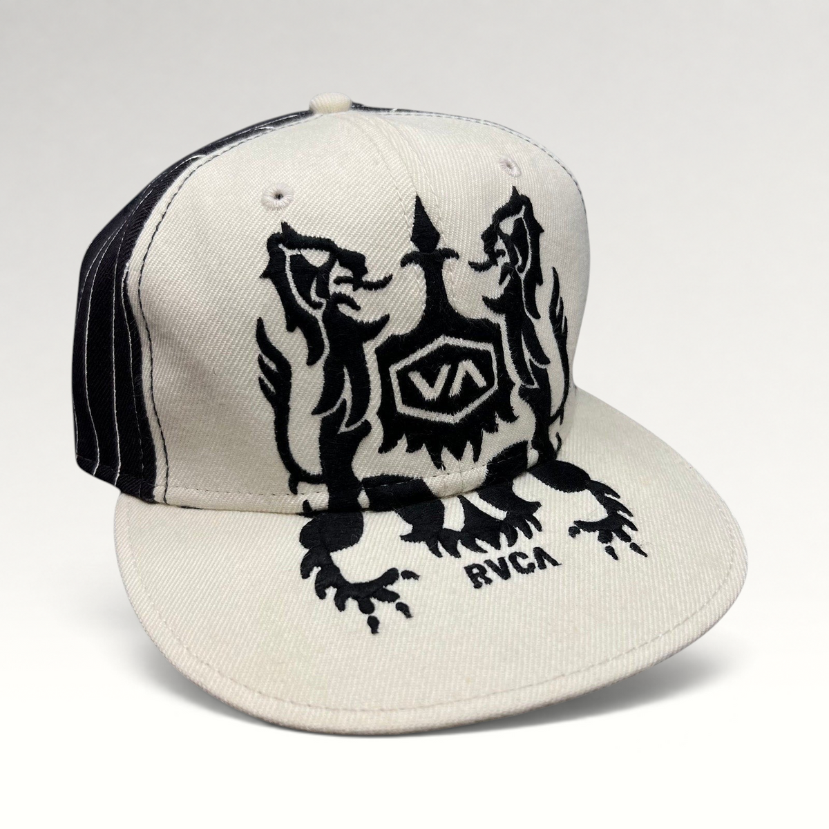 Raree Finds vintage RVCA snapback hat in black and white with a bold crest graphic and flat bill design.