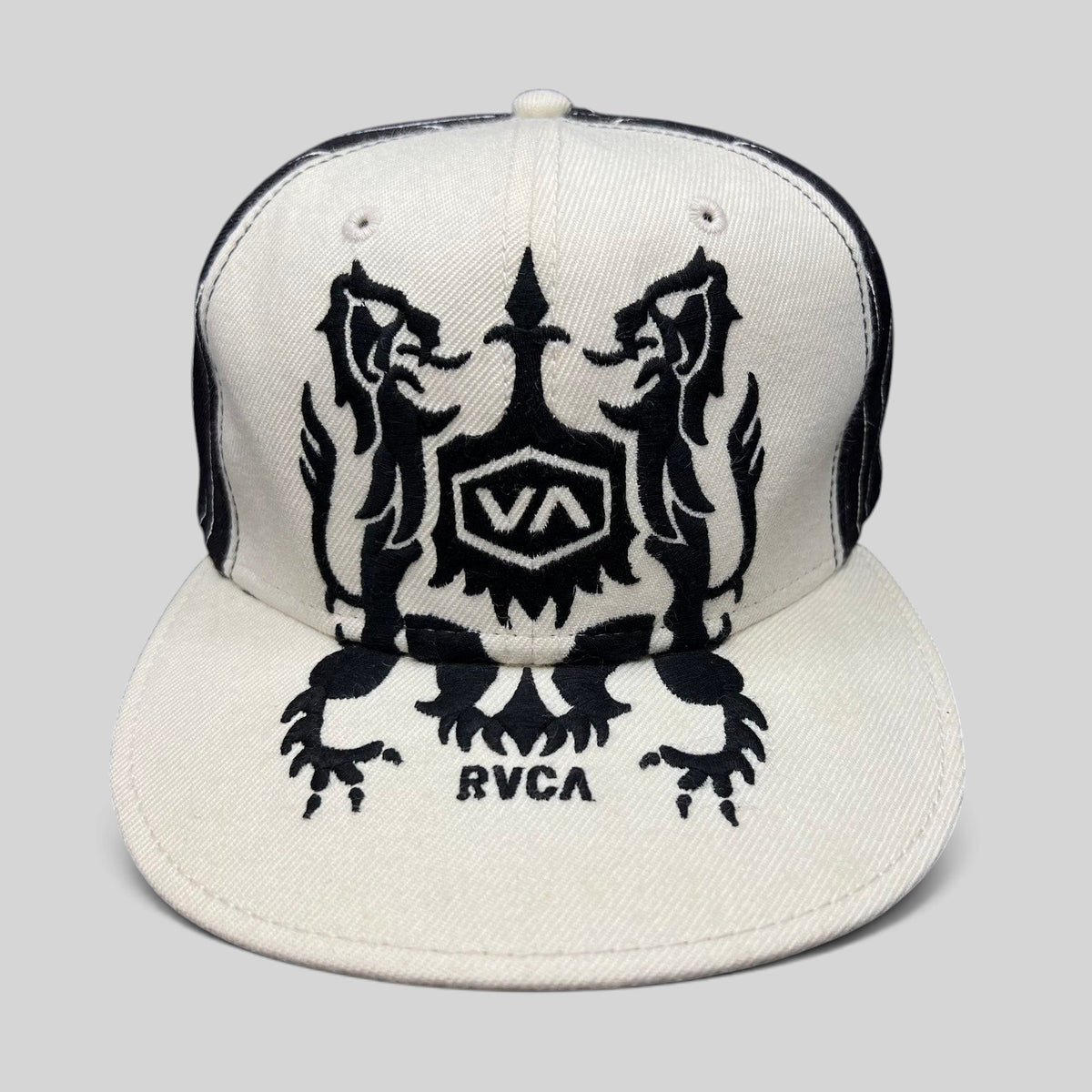 Raree Finds vintage RVCA black and white wool blend snapback hat featuring a symmetrical crest graphic on the crown.