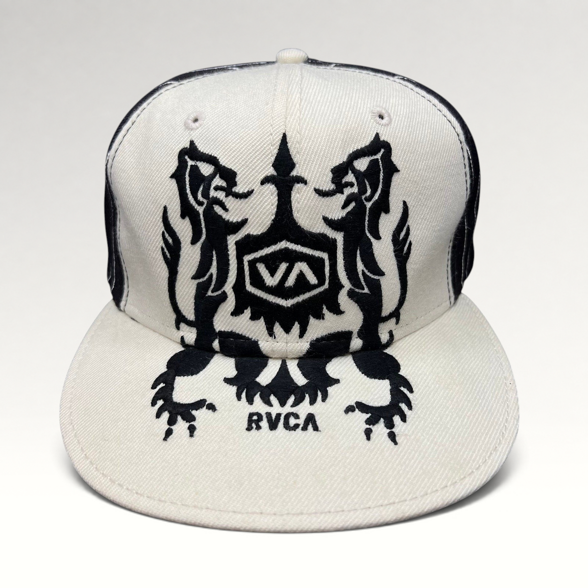 Raree Finds vintage RVCA black and white wool blend snapback hat featuring a symmetrical crest graphic on the crown.