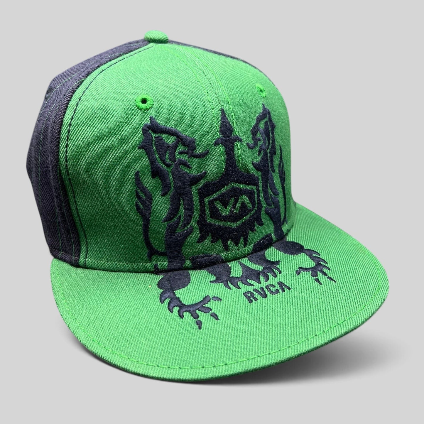Raree Finds vintage green and black RVCA snapback hat featuring a gothic lion crest logo and flat brim