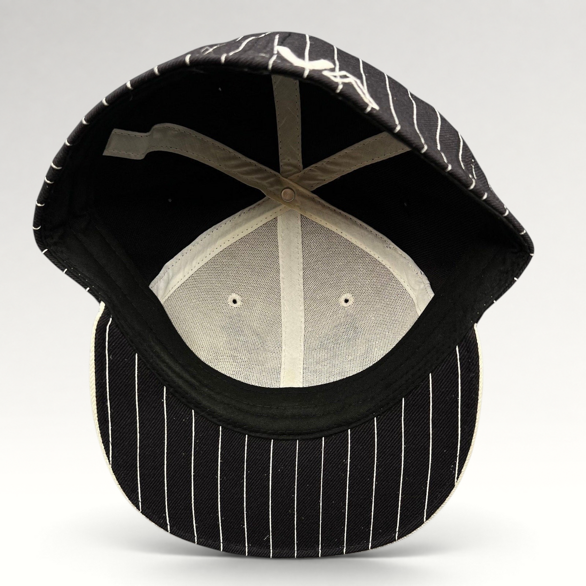 Raree Finds vintage RVCA black and white pinstripe fitted hat with interior view showing structured wool blend crown