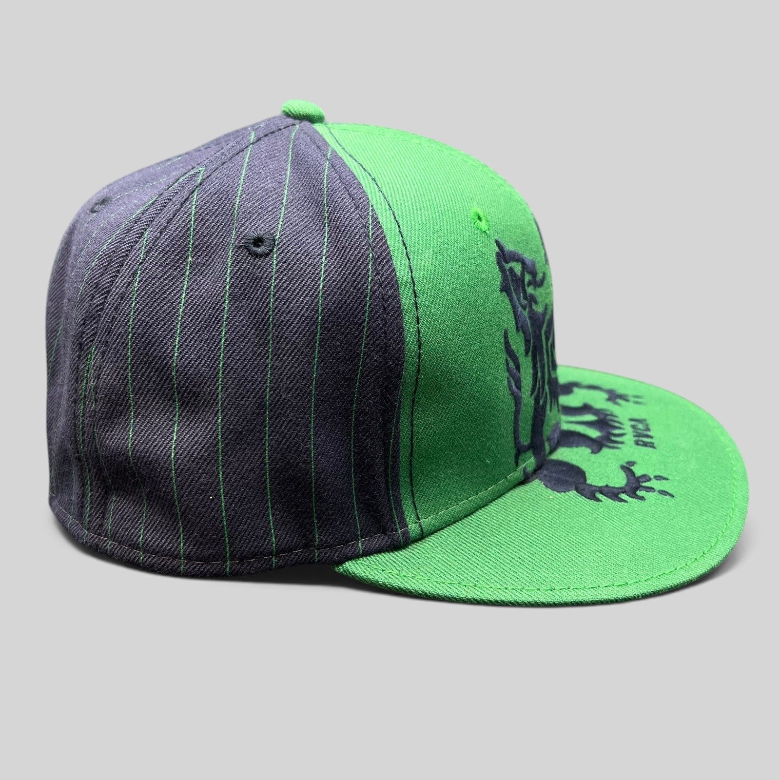 Raree Finds vintage RVCA snapback hat in green and black pinstripe with a lion crest logo on the front panel
