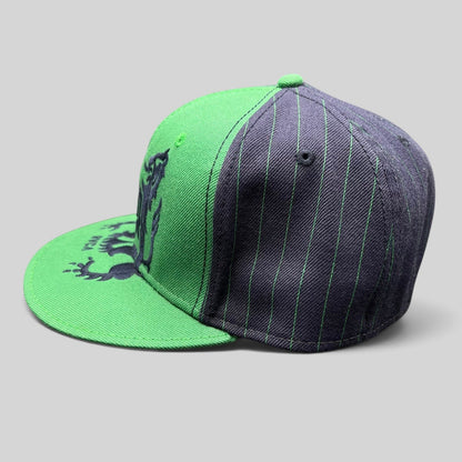 Raree Finds vintage Y2K RVCA snapback hat featuring a green and black pinstripe design with a bold crest logo.