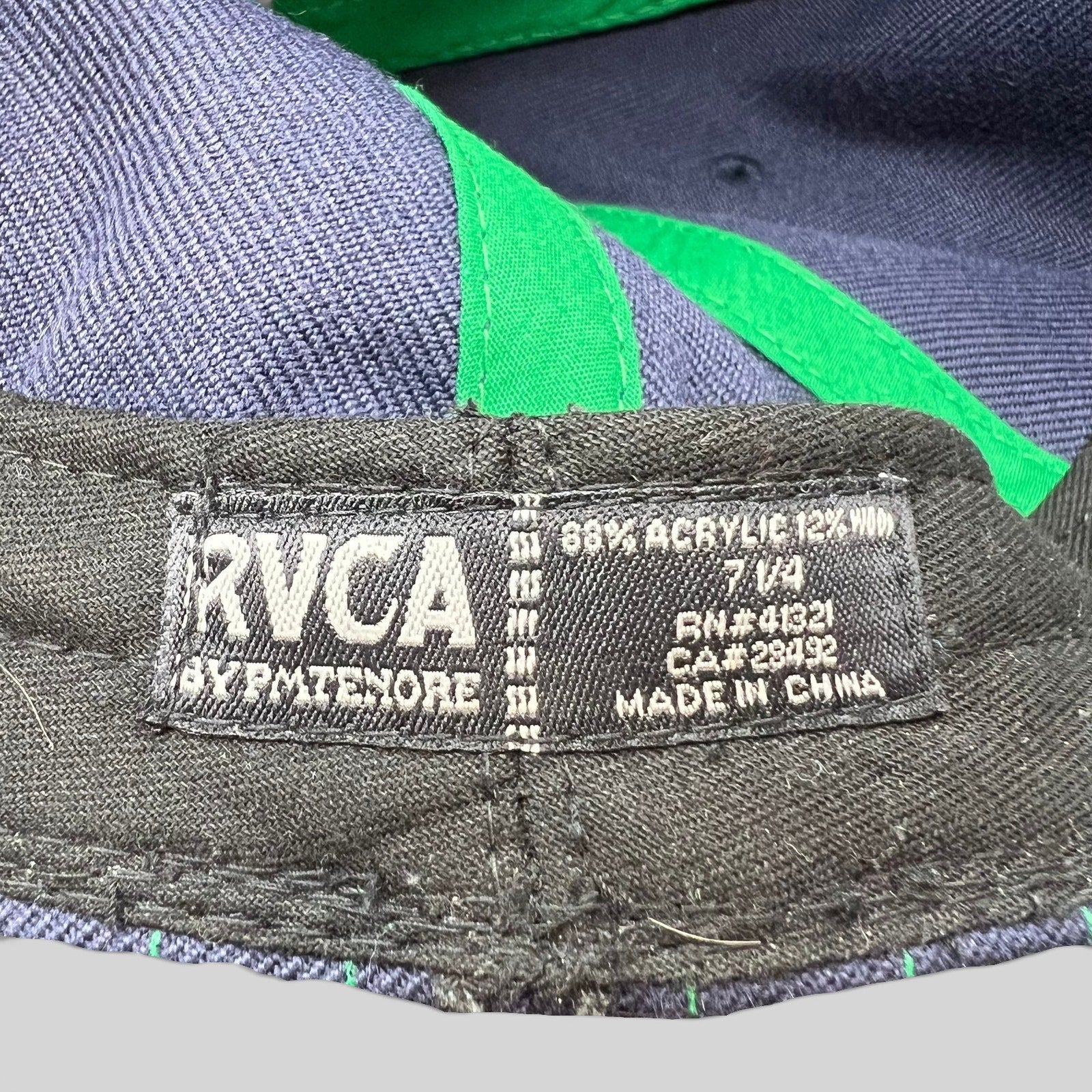 Raree Finds vintage RVCA by PM Tenore hat interior tag showing size 7 1/4 and acrylic wool blend material details