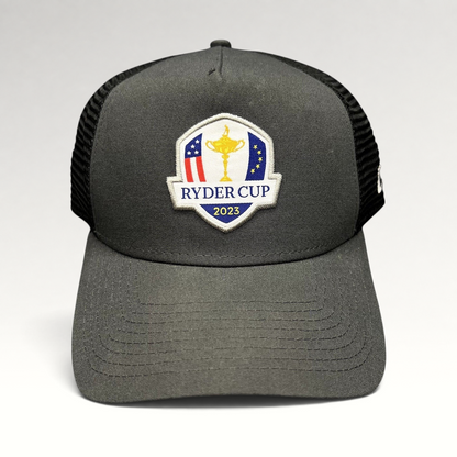 Raree Finds 2023 Ryder Cup New Era snapback trucker hat in charcoal gray and black with embroidered tournament logo