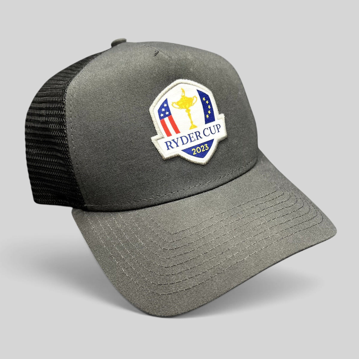 Raree Finds 2023 Ryder Cup snapback trucker hat in charcoal gray with black mesh back and embroidered tournament logo
