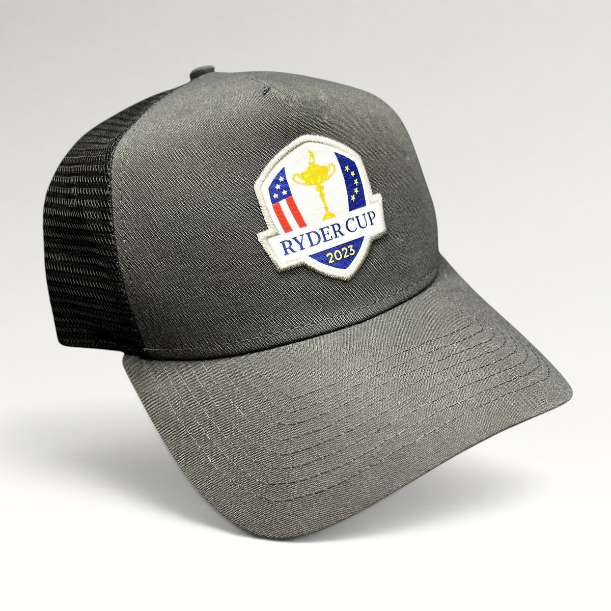 Raree Finds 2023 Ryder Cup snapback trucker hat in charcoal gray with black mesh back and embroidered tournament logo