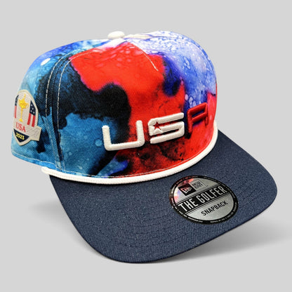 Raree Finds 2023 Ryder Cup Team USA snapback hat with red, white, and blue watercolor crown and navy brim.