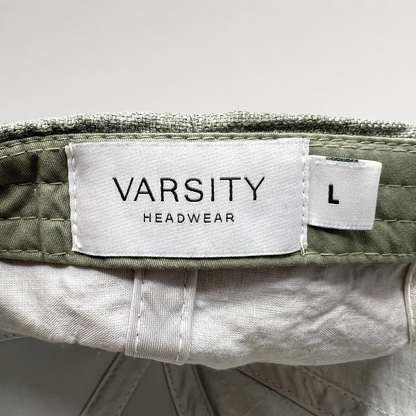 Raree Finds sage green linen cap interior label showing Varsity Headwear branding and size large tag