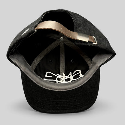Raree Finds Sake Brand black wool-blend strapback cap showing interior details and adjustable leather strap closure.