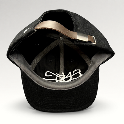Raree Finds Sake Brand black wool-blend strapback cap showing interior details and adjustable leather strap closure.
