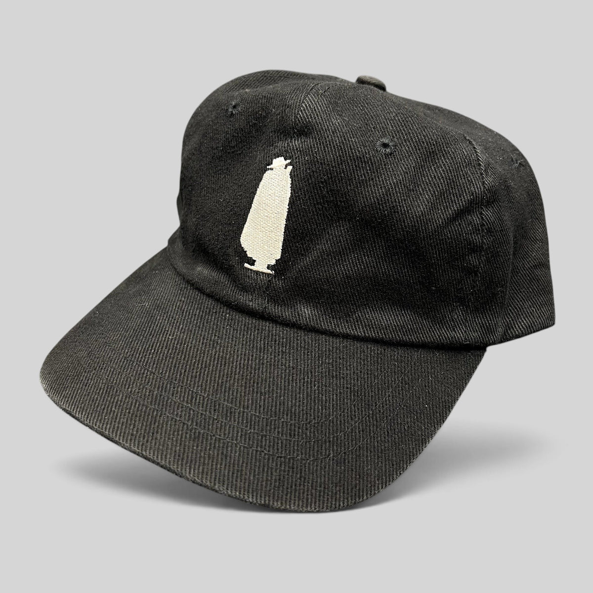 Raree Finds vintage 1990s black cotton dad cap featuring an embroidered white Sandeman port wine bottle logo.