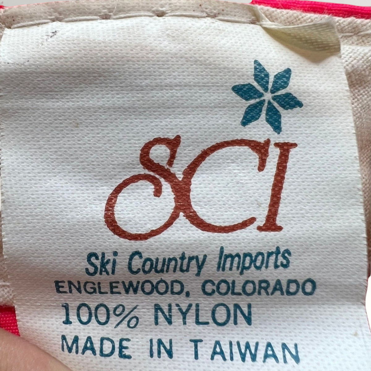 Raree Finds vintage 80s SCI Ski Country Imports nylon hat care label with blue logo and text on white fabric