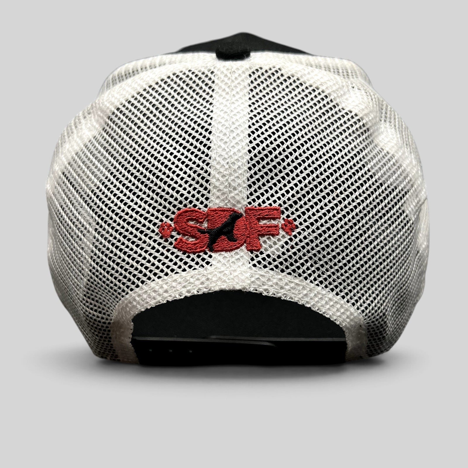 Raree Finds New Era 9FORTY trucker hat back view featuring white mesh panels and red embroidered SDF logo