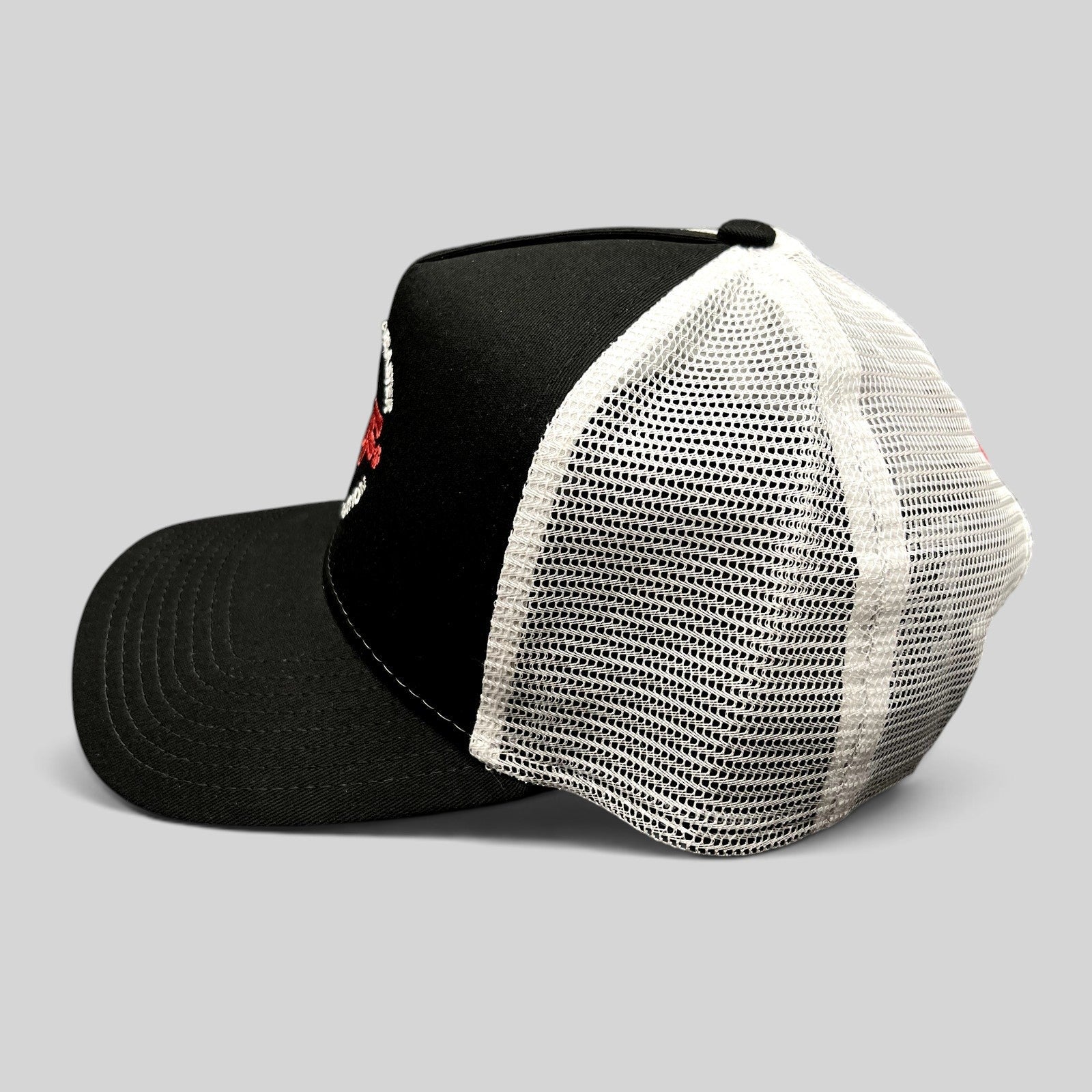 Raree Finds New Era 9FORTY trucker hat in black and white with SDF logo embroidery and adjustable snapback closure.
