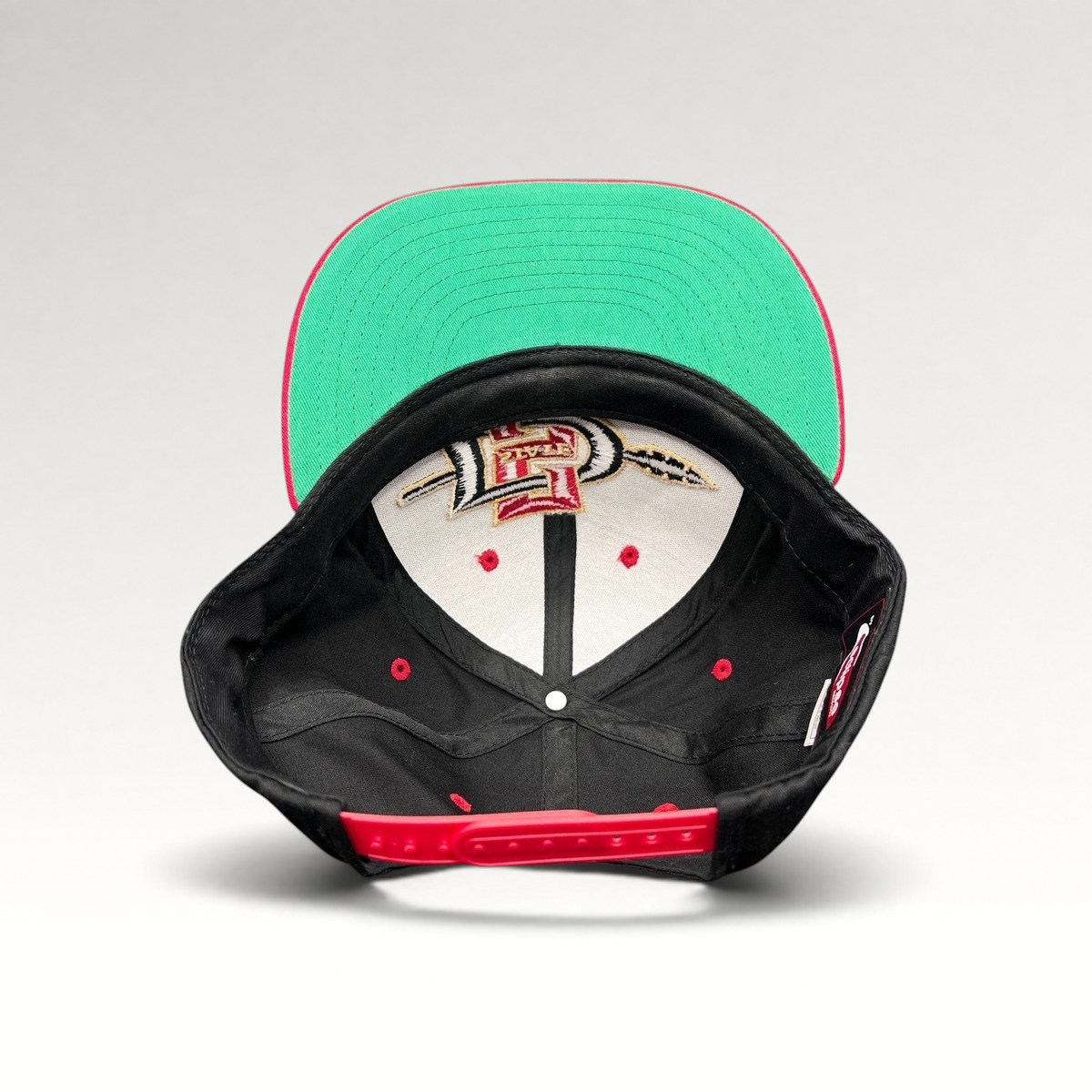 Raree Finds vintage San Diego State Aztecs snapback hat with green undervisor and red adjustable strap