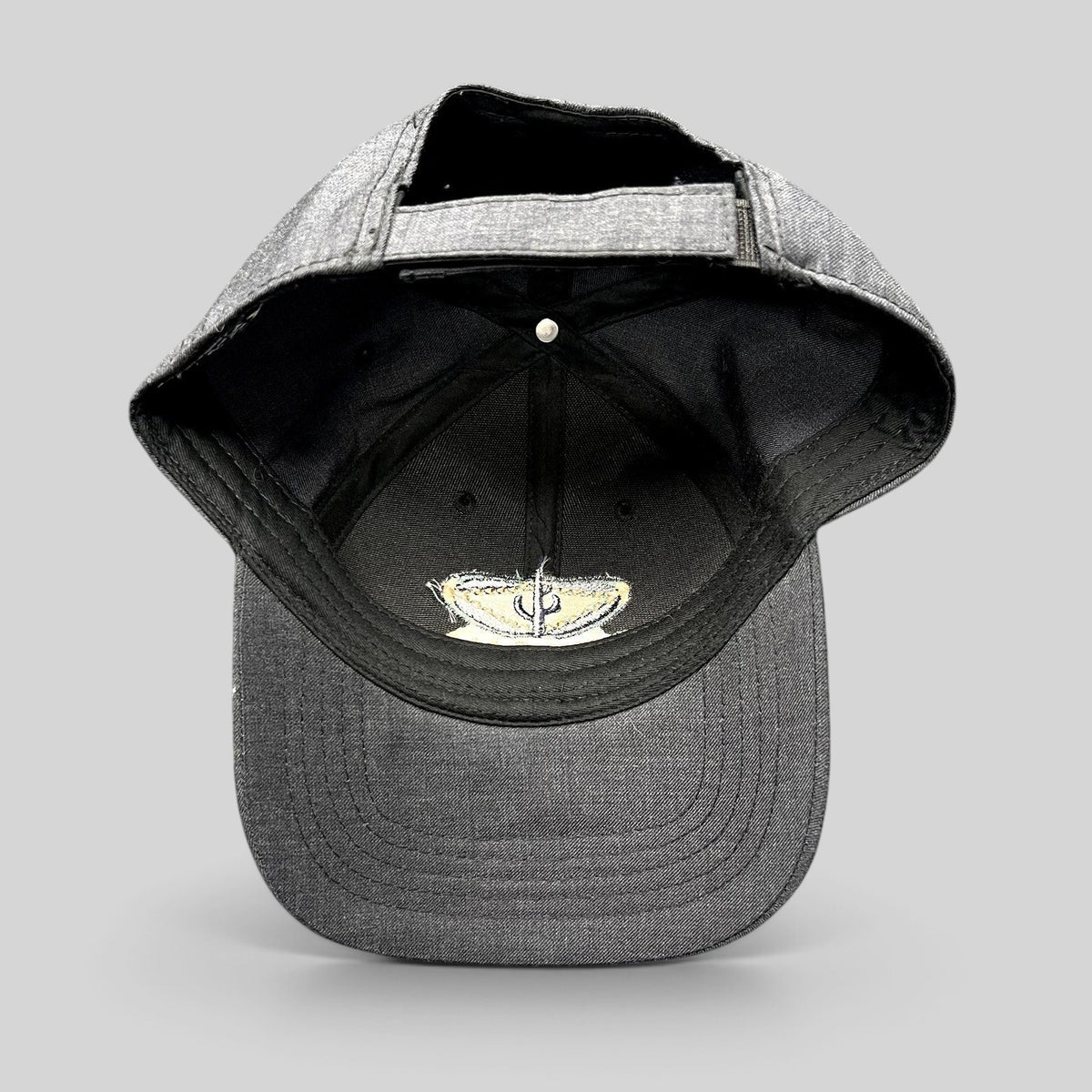Raree Finds vintage sun-faded black cotton strapback hat with Sedona Arizona embroidered logo interior detail