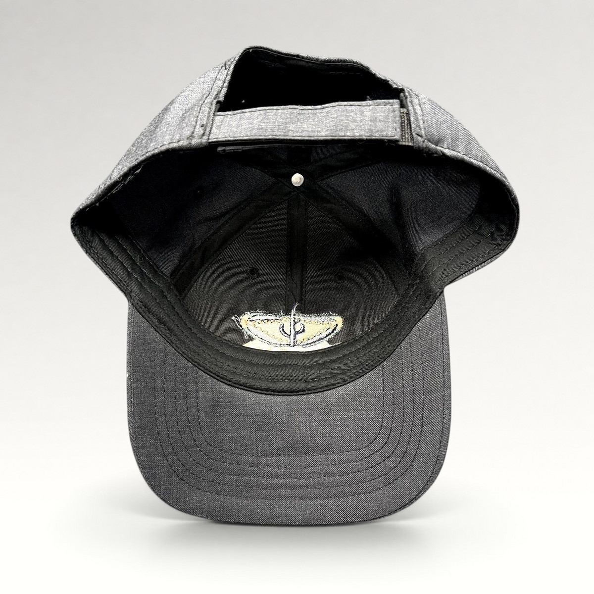 Raree Finds vintage sun-faded black cotton strapback hat with Sedona Arizona embroidered logo interior detail