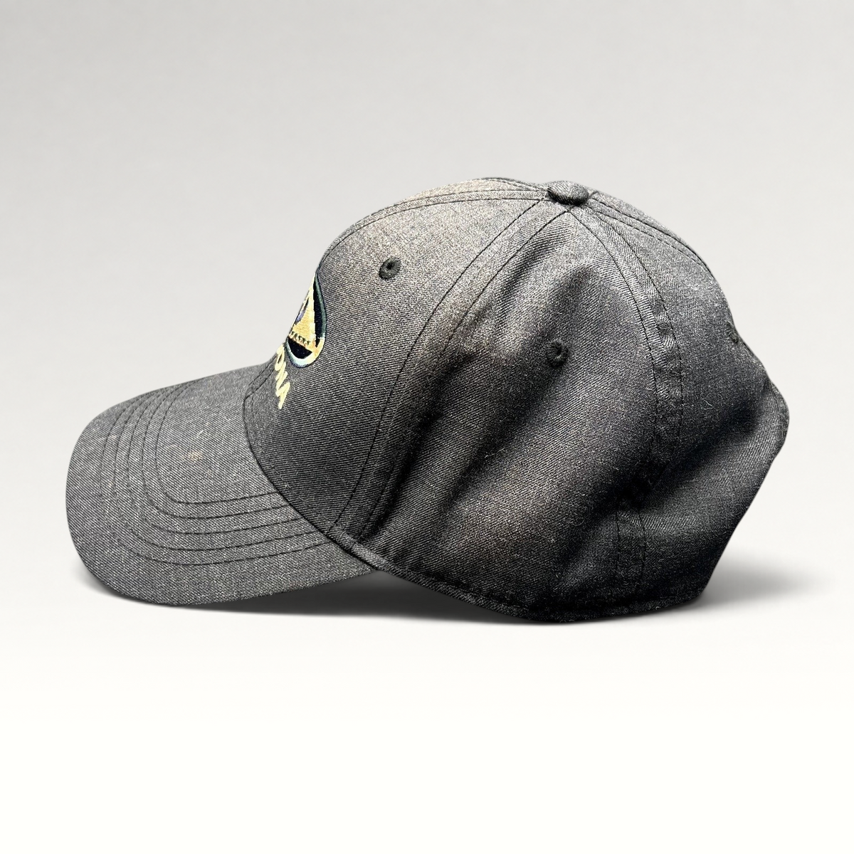 Raree Finds vintage sun-faded black cotton strapback hat with Sedona Arizona embroidered logo, side profile view.